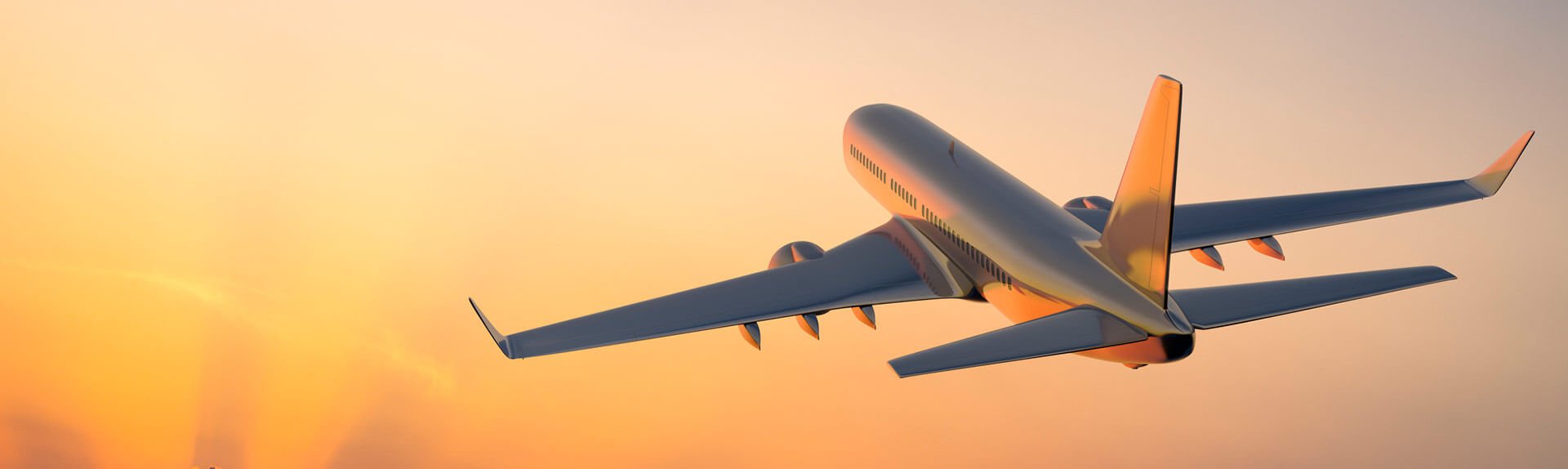 Image of large airplane ascending into the sunset