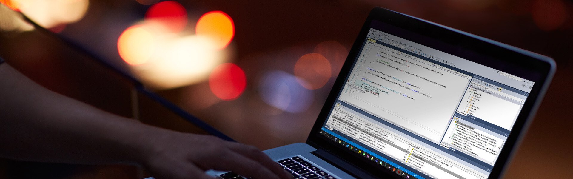 Person typing on computer with dotTEST on screen