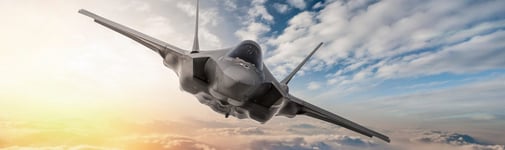 Jet engine flying with clouds and sun in the background