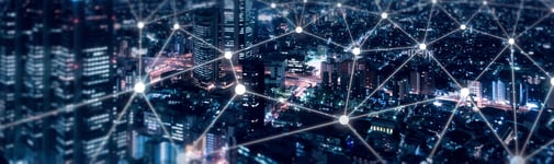 Image of city at night with telecommunications overlay.