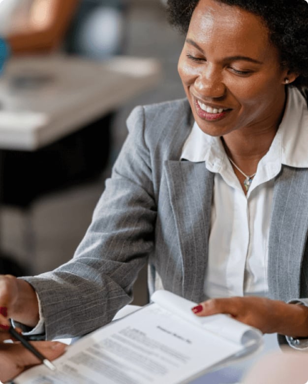 Image of woman holding clipboard with papers for someone to sign